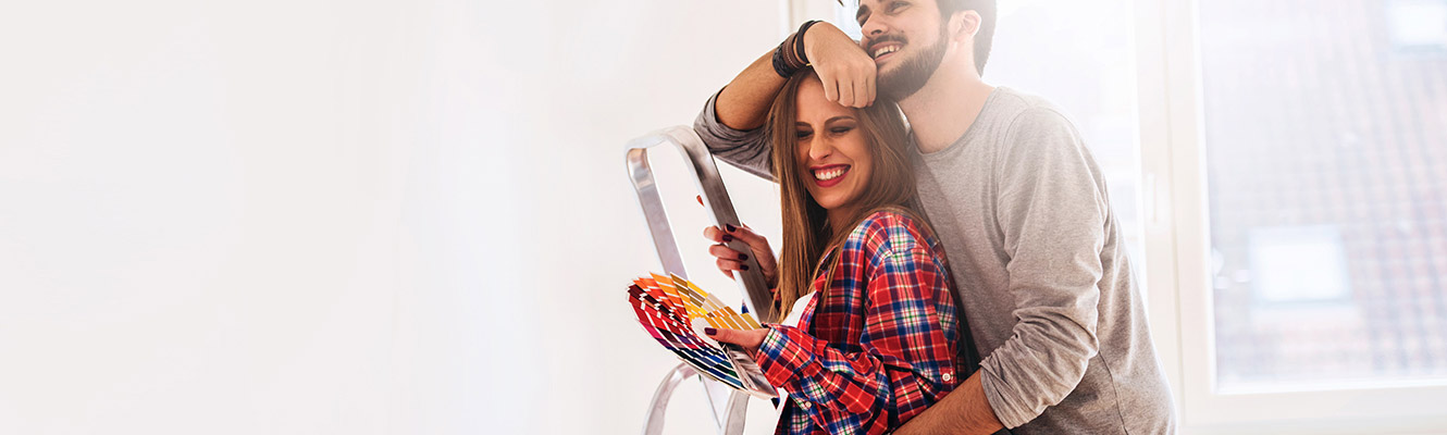 Young couple working on house.