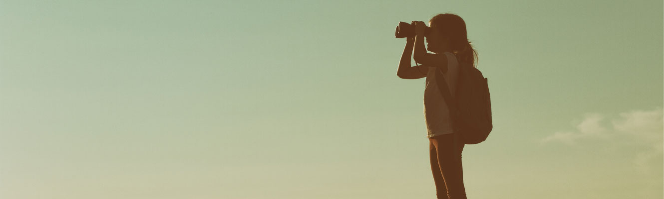 Young girl using binoculars