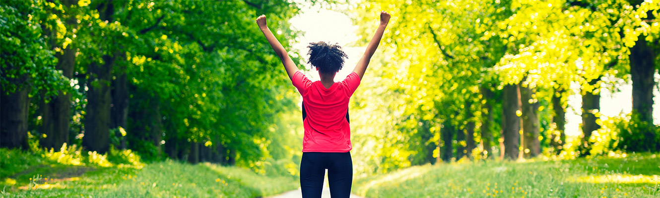 Woman triumphantly finishing her workout. 