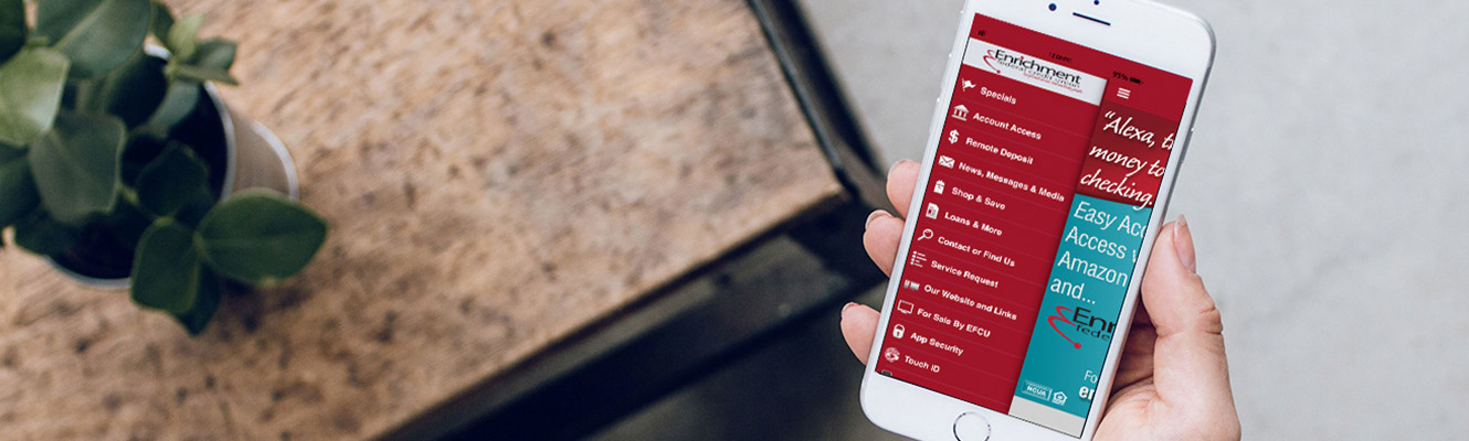 Hand holding a phone with Enrichment App menu on the screen.
