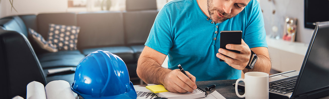 Man sitting at computer calculating finances. 