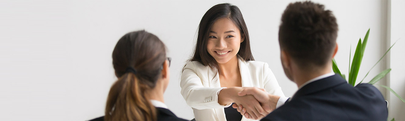 Young woman shaking hands with a man. 